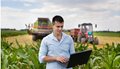 farmer-with-laptop-during-harvest-GettyImages-480915848